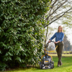 Walk behind lawn mowers with handles that swing to the side to avoid bushes and trees